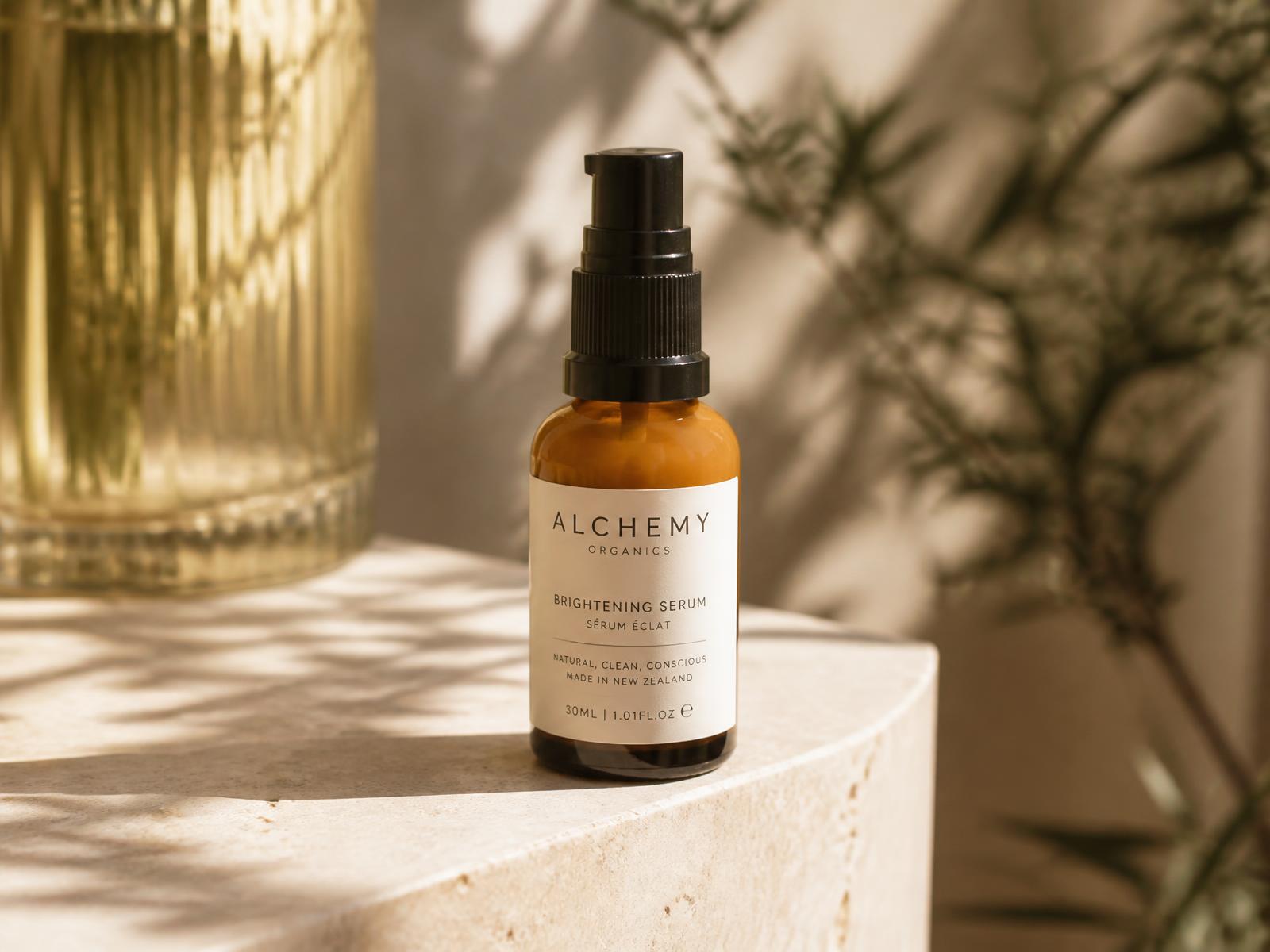 Amber serum bottle rendered on a sunlit stone ledge